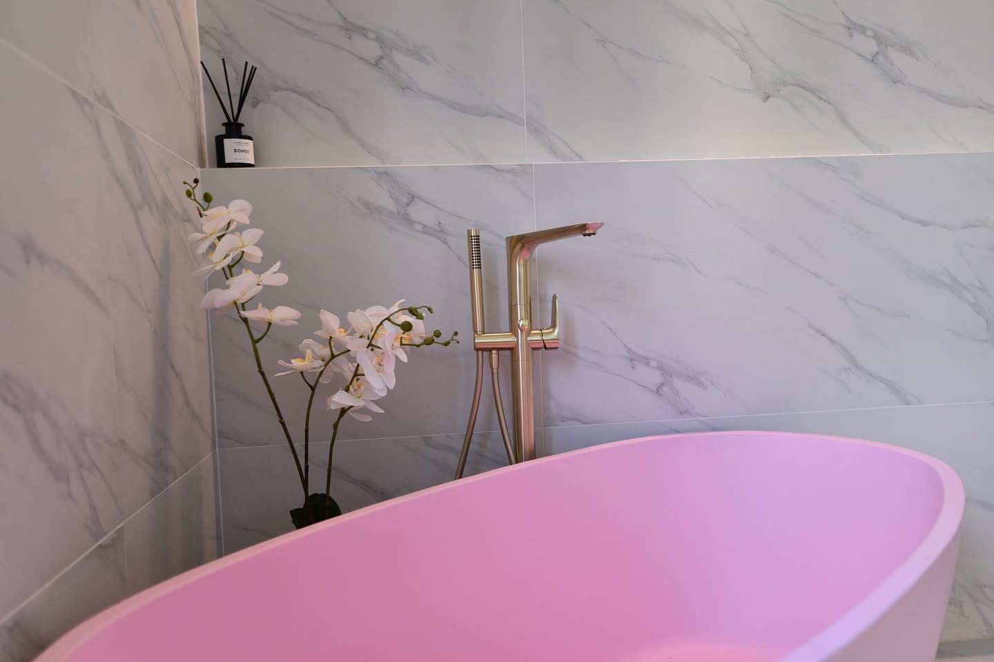 Pink freestanding bath with brushed gold fittings — McMillan Tiling Projects